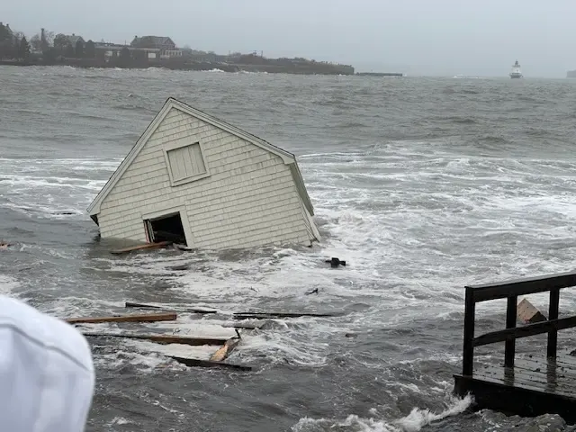 Coastal Bay Shore home taking on Great South Bay water during a storm surge