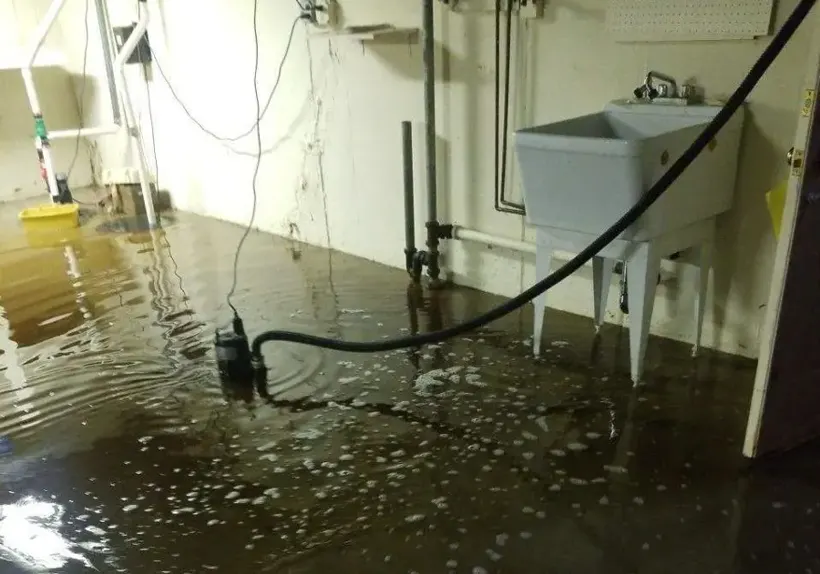 Sump pump and utility area in a flooded Bay Shore basement